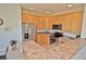 Efficient kitchen with stainless steel appliances, wood cabinets, and a breakfast bar at 9568 W San Juan Cir # 307, Littleton, CO 80128
