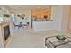 Open-concept living area with a fireplace, dining space, and kitchen access at 9568 W San Juan Cir # 307, Littleton, CO 80128