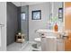 Contemporary bathroom with a glass-enclosed shower, gray tile, and minimalist design at 3665 Estes St, Wheat Ridge, CO 80033