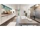 Luxury bathroom features a soaking tub, walk-in shower, and dual vanity at 3665 Estes St, Wheat Ridge, CO 80033