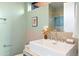 Bright bathroom featuring a modern sink, sleek fixtures, and refreshing light green paint at 3665 Estes St, Wheat Ridge, CO 80033