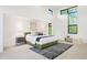 Modern bedroom boasts an abundance of natural light from large windows and high ceilings at 3665 Estes St, Wheat Ridge, CO 80033