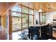 Bright dining area featuring wood ceilings, large windows, and a modern dining set with views of a courtyard at 3665 Estes St, Wheat Ridge, CO 80033