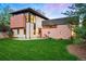 Contemporary home with modern architecture, a well-maintained lawn, and a beautiful garden at 3665 Estes St, Wheat Ridge, CO 80033