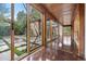 Hallway with wood-paneled ceilings and floor-to-ceiling windows overlooking a landscaped courtyard at 3665 Estes St, Wheat Ridge, CO 80033