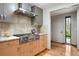 Updated kitchen features granite countertops, stainless steel appliances, and custom cabinetry at 3665 Estes St, Wheat Ridge, CO 80033