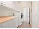 Functional laundry room with ample cabinet space, modern appliances, and tiled floors at 3665 Estes St, Wheat Ridge, CO 80033