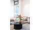 Relaxing living area featuring a modern coffee table, a comfortable sofa, and stylish decor with natural light at 3665 Estes St, Wheat Ridge, CO 80033