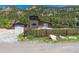 Charming exterior view of home with fenced yard and mountain views at 1500 Buckeye Cir, Georgetown, CO 80444