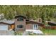 Exterior aerial view of home featuring a fenced yard, deck and mountain views at 1500 Buckeye Cir, Georgetown, CO 80444