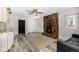 Living room with stone fireplace, ceiling fan, wood-look flooring, and access to kitchen and outdoor area at 1500 Buckeye Cir, Georgetown, CO 80444
