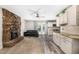 Living room showcases a stone fireplace, wood-look floors, and an open layout connecting to the kitchen at 1500 Buckeye Cir, Georgetown, CO 80444