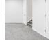 Partially finished basement with neutral carpet and white walls at 12965 Grassland St, Longmont, CO 80504