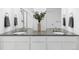 Bathroom featuring double sinks, gray countertops, and a neutral color palette at 12965 Grassland St, Longmont, CO 80504