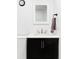 Modern bathroom featuring a sleek vanity with a black cabinet and white countertop at 12965 Grassland St, Longmont, CO 80504