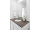 Bathroom with a single sink, gray countertop, and neutral decor at 12965 Grassland St, Longmont, CO 80504