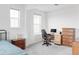 Comfortable bedroom with ample natural light, a wooden desk, and a traditional wood dresser at 12965 Grassland St, Longmont, CO 80504