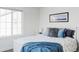 Comfortable bedroom with large window and blue accents at 12965 Grassland St, Longmont, CO 80504