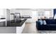 Bright, open kitchen featuring an island with dark countertops, white cabinetry, and modern stainless appliances at 12965 Grassland St, Longmont, CO 80504