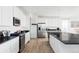 Contemporary kitchen showcasing white cabinets, stainless appliances, and a functional layout at 12965 Grassland St, Longmont, CO 80504