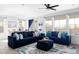 Inviting living room with cozy blue sofas, area rug, large windows and dining room in the background at 12965 Grassland St, Longmont, CO 80504