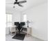 Bright home office with desk setup, ample natural light, and ceiling fan at 12965 Grassland St, Longmont, CO 80504