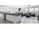 Stylish living area featuring an open layout connecting the kitchen, dining, and living spaces at 12965 Grassland St, Longmont, CO 80504