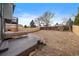 Spacious fenced backyard with a deck and ample space for outdoor activities at 5773 W 76Th Dr, Arvada, CO 80003