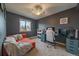 Comfortable bedroom with window, fan and a desk setup, offering a cozy and functional space at 5773 W 76Th Dr, Arvada, CO 80003