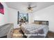 Bright bedroom with a large window and plants; ceiling fan provides light and air circulation at 5773 W 76Th Dr, Arvada, CO 80003