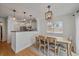 Cozy dining area with wooden floors and an open layout to the kitchen at 5773 W 76Th Dr, Arvada, CO 80003
