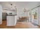 Bright dining area with hardwood floors, stylish lighting, and sliding door access to the deck at 5773 W 76Th Dr, Arvada, CO 80003