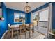 Bright dining area showcasing stylish light fixture, natural light, and sliding door access to the deck at 5773 W 76Th Dr, Arvada, CO 80003