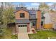 Charming two-story home featuring brick accents, solar panels, and a well-maintained front yard at 5773 W 76Th Dr, Arvada, CO 80003