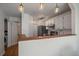 Bright kitchen featuring white cabinets, stainless steel appliances, and an open layout at 5773 W 76Th Dr, Arvada, CO 80003