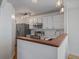Well-lit kitchen with white cabinets, stainless steel appliances, and modern fixtures at 5773 W 76Th Dr, Arvada, CO 80003