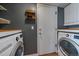 Practical laundry room with modern washer and dryer, storage, and access door, making chores easier at 5773 W 76Th Dr, Arvada, CO 80003