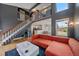 Bright living room with open floor plan, featuring a staircase and comfortable seating at 5773 W 76Th Dr, Arvada, CO 80003