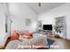 Comfortable living room features vaulted ceiling, modern lighting, and cozy seating area with a large TV at 5773 W 76Th Dr, Arvada, CO 80003