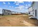 A view of the the yard and nearby houses. A wooden fence separates the yard from the other homes at 2186 Flower Blossom Ave, Brighton, CO 80601