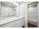 Bright bathroom featuring a white vanity with modern finishes, a large mirror, and a combined bathtub and shower at 2186 Flower Blossom Ave, Brighton, CO 80601
