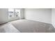 Unfurnished bedroom with plush new carpeting and natural light from two windows at 2186 Flower Blossom Ave, Brighton, CO 80601