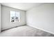 A bedroom bathed in sunlight, featuring soft carpeting and views of the neighborhood at 2186 Flower Blossom Ave, Brighton, CO 80601