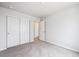 An airy bedroom with a closet, soft carpeting, and a doorway to a hallway or adjacent room at 2186 Flower Blossom Ave, Brighton, CO 80601