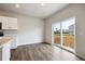 Dining area with sliding door leading to the yard, adjacent to the kitchen at 2186 Flower Blossom Ave, Brighton, CO 80601
