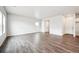 Open living area with sleek hardwood floors, neutral walls, and plenty of natural light at 2186 Flower Blossom Ave, Brighton, CO 80601