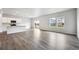 Spacious open-concept living room featuring hardwood floors and ample natural light at 2186 Flower Blossom Ave, Brighton, CO 80601
