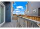 Charming back porch features a painted railing and views of a shared back yard at 730 Cottonwood Ave, Bennett, CO 80102