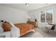 Relaxing bedroom features natural light, modern furnishings, and a cozy chair at 730 Cottonwood Ave, Bennett, CO 80102