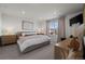This spacious bedroom features soft carpeting, recessed lighting, and a large window at 730 Cottonwood Ave, Bennett, CO 80102